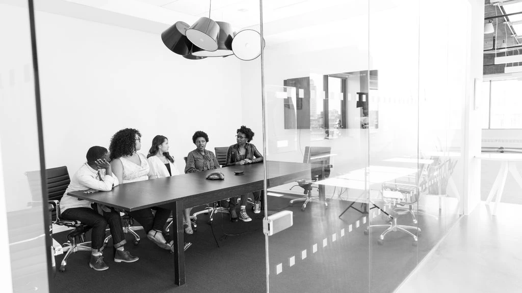 Empty conference room with scattered meeting notes after an awkward all-hands